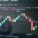 A graph showing Bitcoin's decline alongside rising oil prices.
