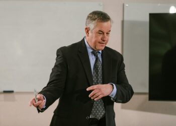 MARA CEO speaks at a conference, discussing Bitcoin treasury strategy and market speculation.