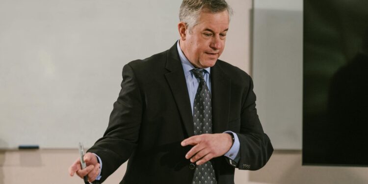 MARA CEO speaks at a conference, discussing Bitcoin treasury strategy and market speculation.