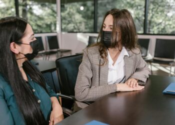 Employees at a government office discussing cryptocurrency security measures.