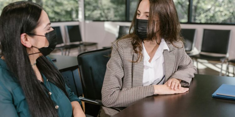 Employees at a government office discussing cryptocurrency security measures.