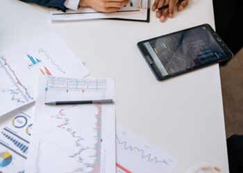 Senators discussing stablecoin regulation with financial charts and documents on a table.