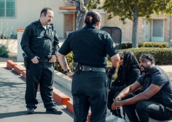 Police officers examining cryptocurrency transactions related to a revenge scheme.