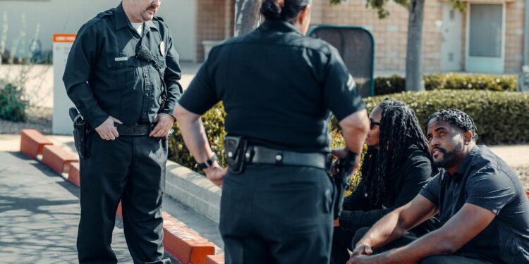 Police officers examining cryptocurrency transactions related to a revenge scheme.
