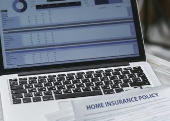 Blockchain technology displayed on a digital screen alongside financial charts and documents.