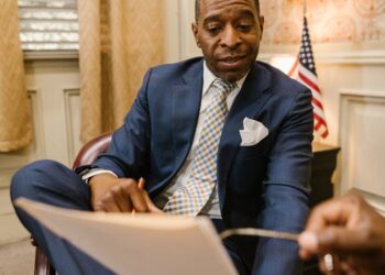 Authorities reviewing cryptocurrency graphics with regulatory documents and a North Korean flag.