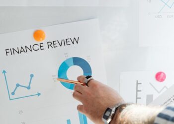 Financial advisor reviewing cryptocurrency options for 401(k) plans with charts and graphs.