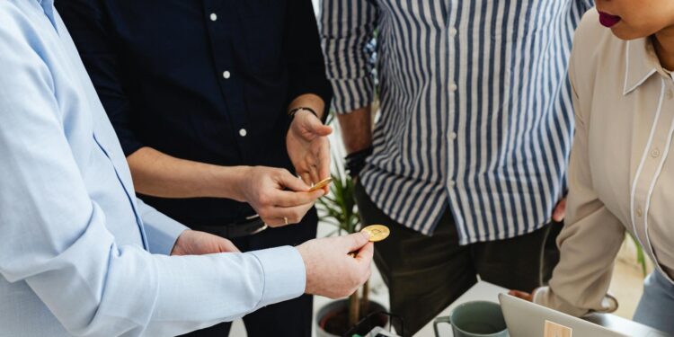 Investors discussing cryptocurrency governance changes at a meeting.