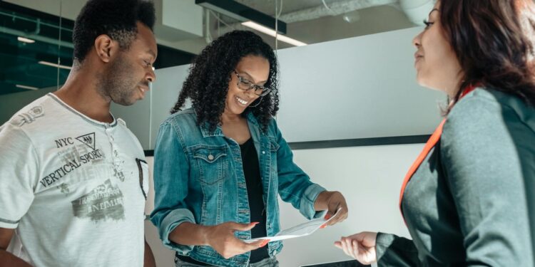 Zerohash team discusses bank charter application in a modern office setting.