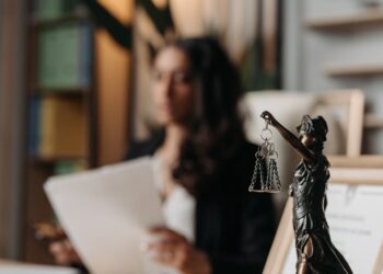 JPMorgan logo overlaid on a blurred background of cryptocurrency graphics and legal documents.