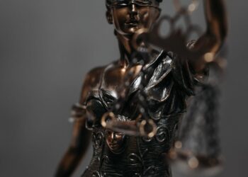 USDT cryptocurrency coins with a gavel and scales, symbolizing legal action in a scam case.