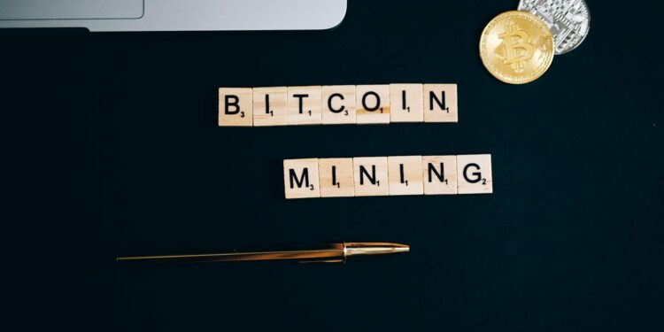 A mining facility with rows of Bitcoin mining rigs and overhead power lines.