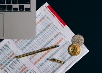 Bitcoin coin surrounded by financial graphs and regulatory documents, symbolizing scrutiny.