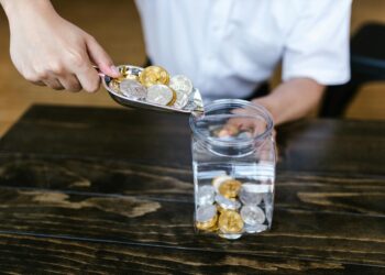 Gold coins and crypto tokens scattered on a table, representing stablecoin thUSD launch.