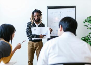 Legislators discussing crypto regulation at a conference table, with documents and charts visible.