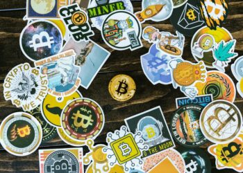 A busy Tokyo street with cryptocurrency symbols and Bitcoin signage in the background.