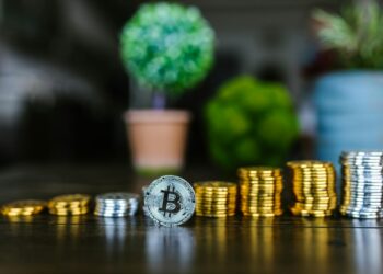 Stacks of USDT cryptocurrency coins with a backdrop of financial documents and regulations.