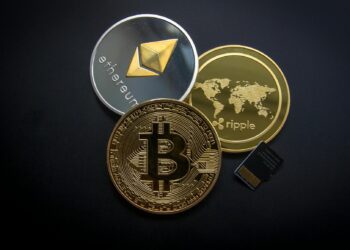 Mastercard logo in front of digital banking graphics and cryptocurrency symbols.