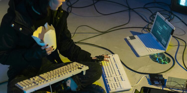 North Korean hackers working on computers with crypto-related visuals in the background.
