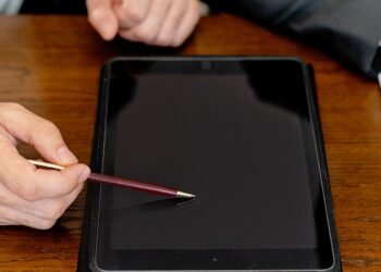 Two businesspeople discussing digital asset strategies in a modern office setting.