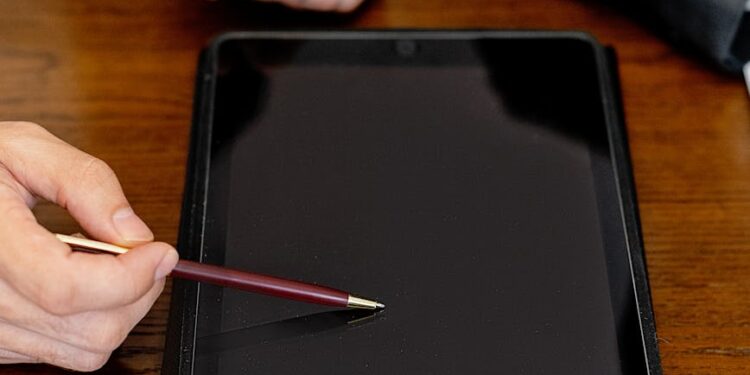 Two businesspeople discussing digital asset strategies in a modern office setting.