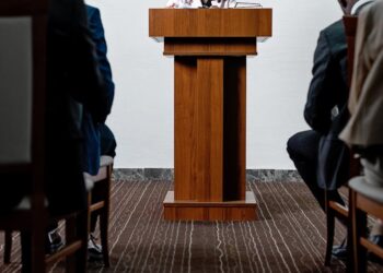 Nader Al-Naji speaking at a cryptocurrency conference, discussing regulatory challenges.