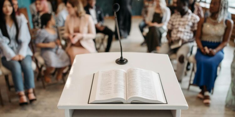 CFTC Chair speaks at podium during public forum on prediction markets regulation.