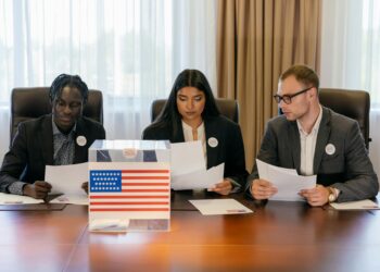 SEC and CFTC officials discussing cryptocurrency regulation at a conference table.