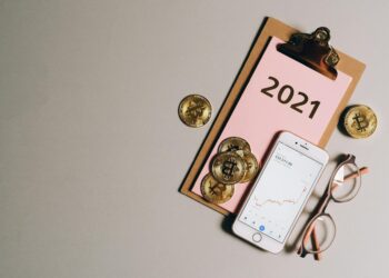 A stock chart with rising trends and golden tokens represents crypto investments in gold.