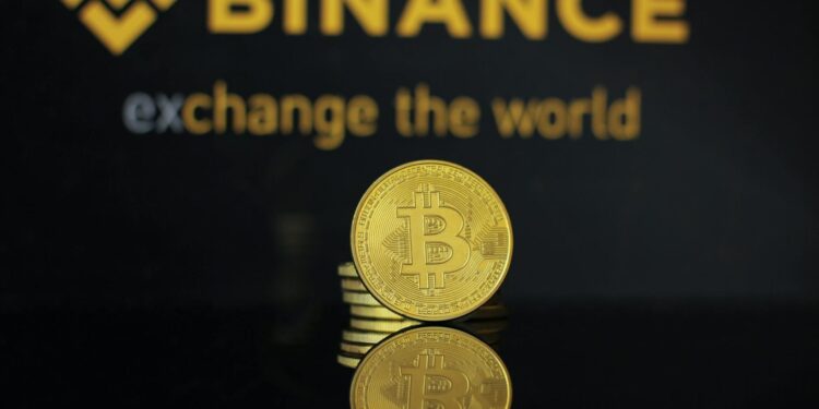 A Binance logo displayed at a financial conference amidst discussions on crypto regulations.