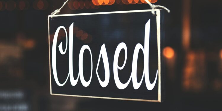 Bitcoin Depot kiosk with warning signs posted about suspended operations in Connecticut.