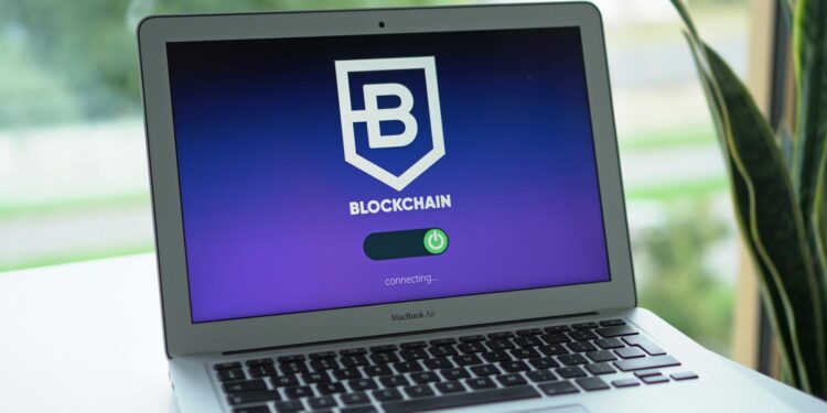 Mitsubishi logo with blockchain graphics and JPMorgan Kinexys branding in the background.