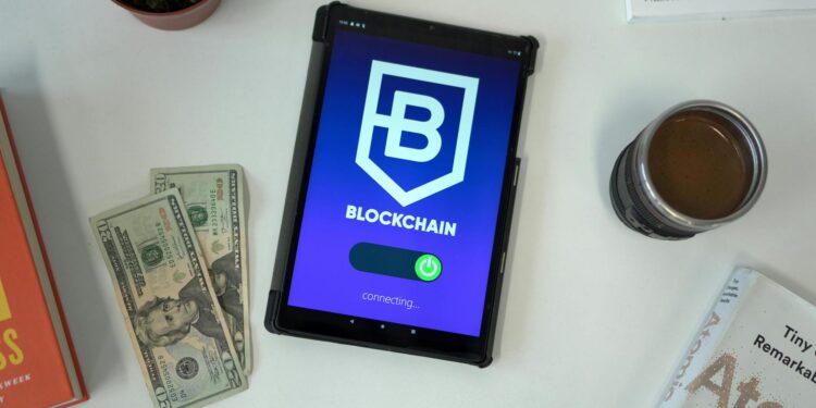 Stacks of US dollars next to a smartphone displaying a cryptocurrency wallet app.