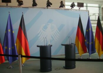 Logo of Anthropic displayed at a press conference on AI regulation debates.