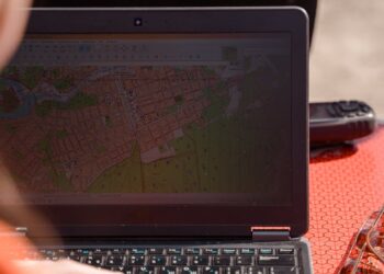 Military personnel analyzing maps and satellite images in a high-stakes planning session.