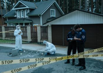 Police conducting an operation related to crypto kidnappings, with evidence bags and suspects.