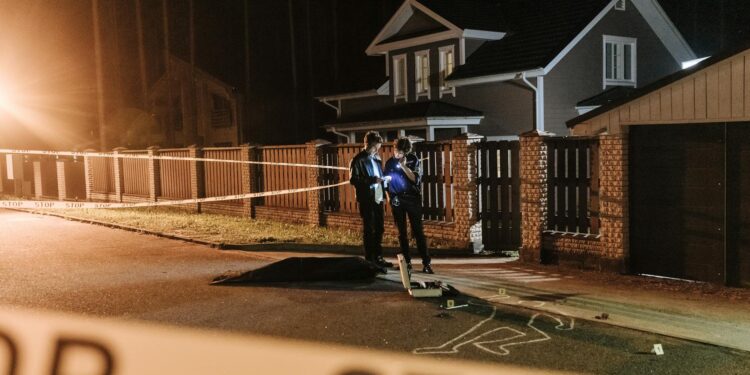 A city skyline with police tape and investigators examining a crypto office.