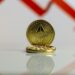 Graph showing Ethereum price drop with a large red downward arrow and company logo.