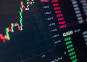 Bitcoin chart showing a steep decline, with a graphic representation of market volatility.