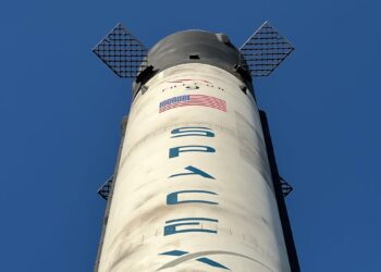 A SpaceX rocket with Cursor AI logo in the background signifies a major financial partnership.