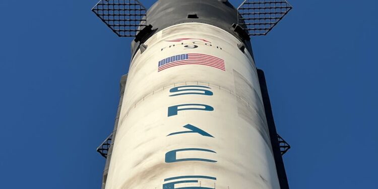 A SpaceX rocket with Cursor AI logo in the background signifies a major financial partnership.
