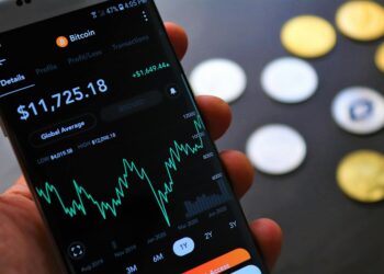 A smartphone displaying the SoFi app with XRP cryptocurrency interface.