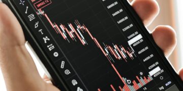 Graph showing Bitcoin price trends with a warning alert for service outage.