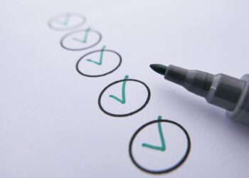 Graphic showing various crypto tokens with green checkmarks, symbolizing approval for Japan's Green List.