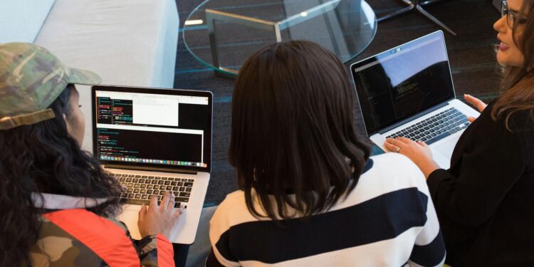 Participants collaborating on blockchain projects at the TRON DAO-sponsored hackathon.