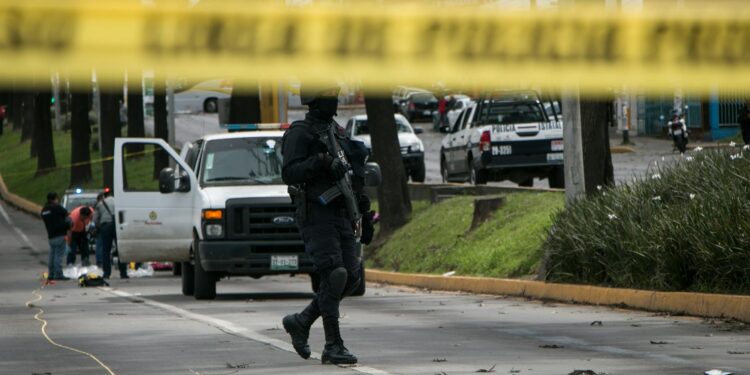 Police at a crime scene near a school, investigating a recent shooting incident.