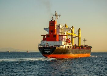 Iranian Revolutionary Guard vessels intercept commercial ships in the Strait of Hormuz.