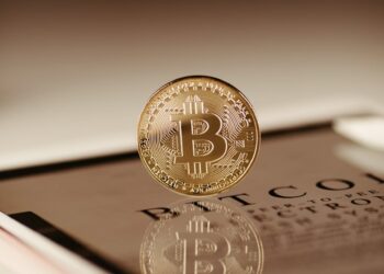 A Cango Inc. logo with Bitcoin symbols transforming into AI icons, representing a business transition.