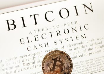 Bitcoin symbol with a price tag showing $75,000, Nasdaq and S&P 500 graphs in the background.