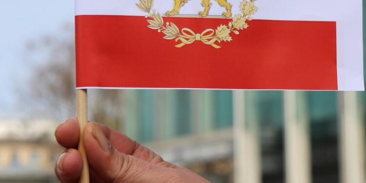 Iranian officials discussing cryptocurrency regulations with a backdrop of the Revolutionary Guards emblem.